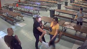 principal dragging student to the ground